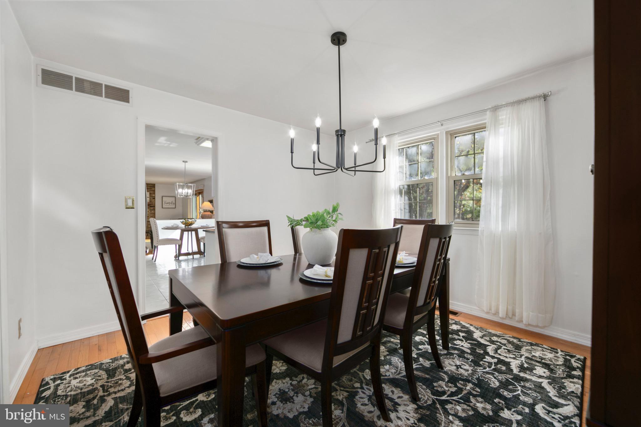 219 Dock Road Marlton, NJ 08053 - Photo 7 of 51 a view of a dining room with furniture a chandelier and wooden floor