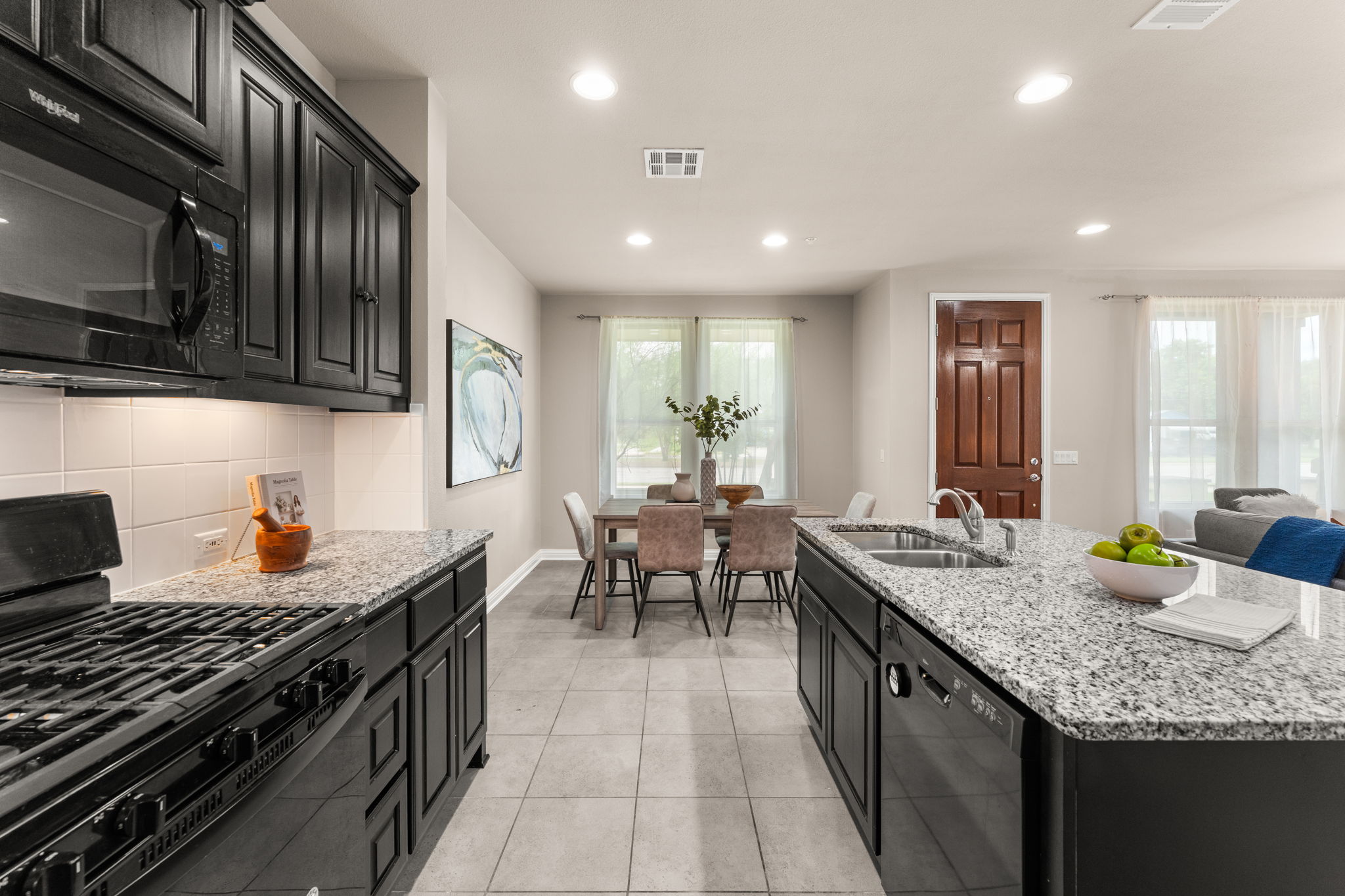 6814 East Riverside Drive, Unit 21 Austin, TX 78741 - Photo 10 of 35 a kitchen with granite countertop lots of counter top space a sink stainless steel appliances and cabinets