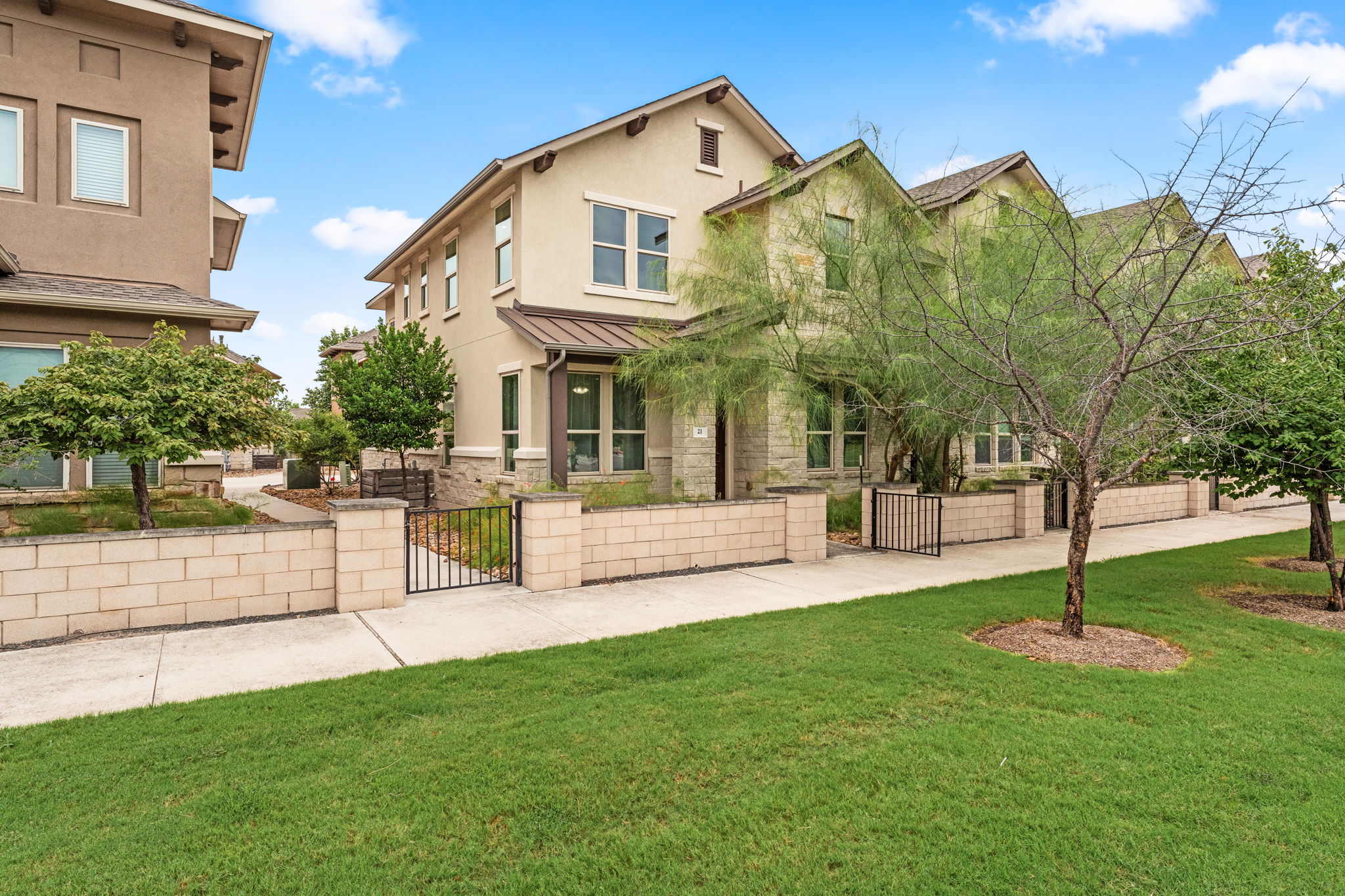 6814 East Riverside Drive, Unit 21 Austin, TX 78741 - Photo 2 of 35 a front view of a building with a garden and trees