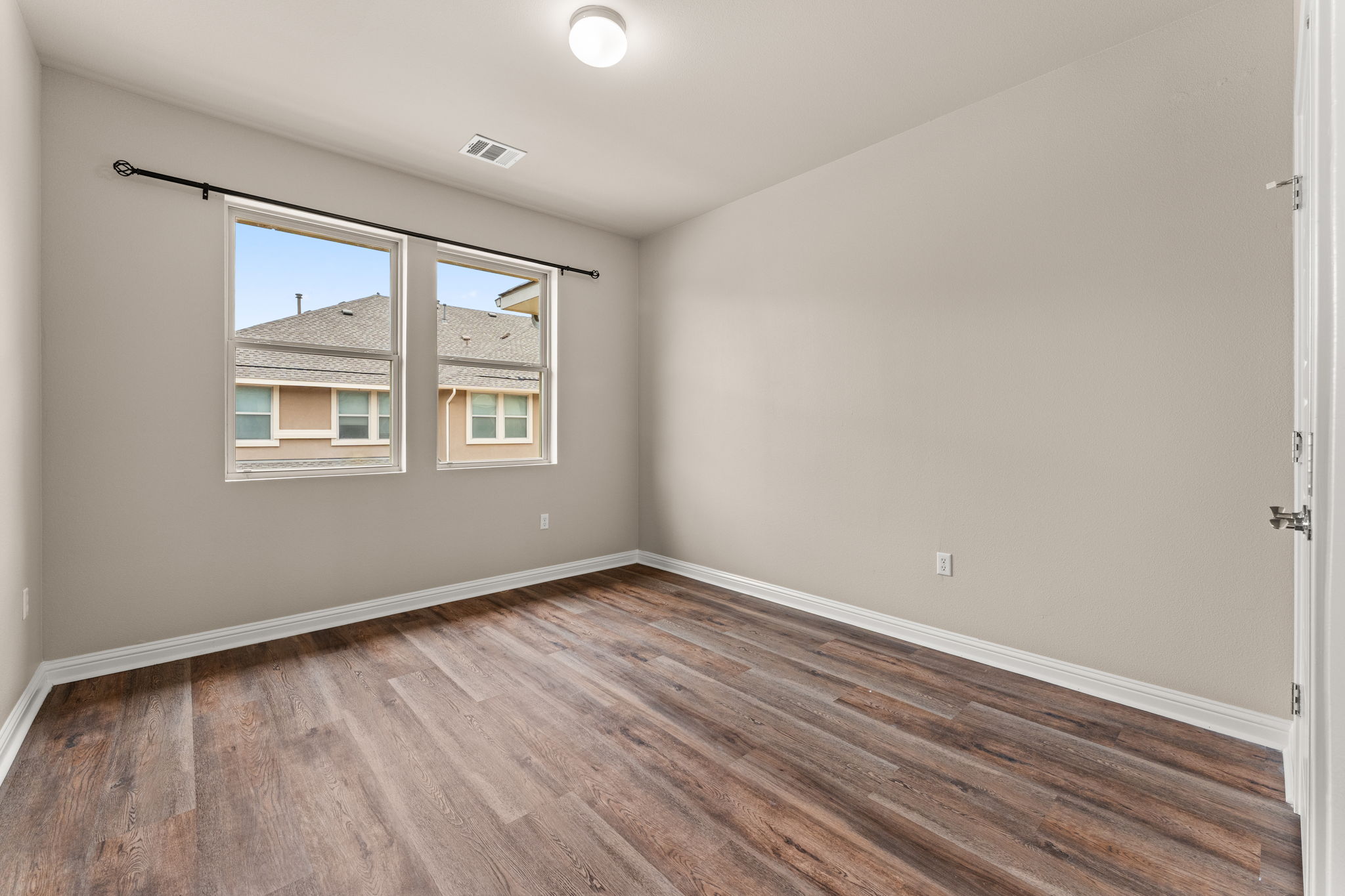 6814 East Riverside Drive, Unit 21 Austin, TX 78741 - Photo 20 of 35 an empty room with wooden floor and windows