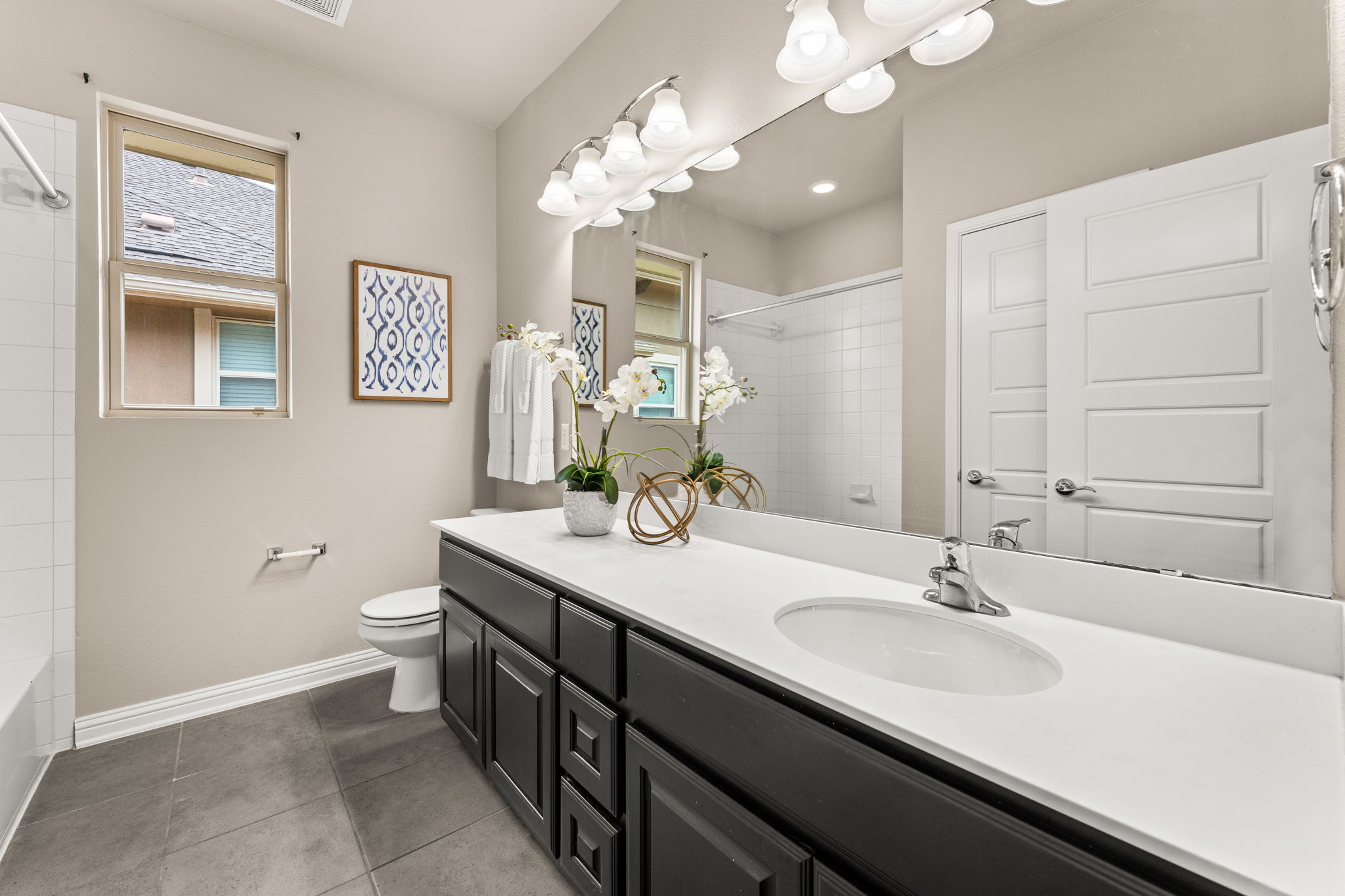 6814 East Riverside Drive, Unit 21 Austin, TX 78741 - Photo 21 of 35 a bathroom with a double vanity sink mirror and toilet
