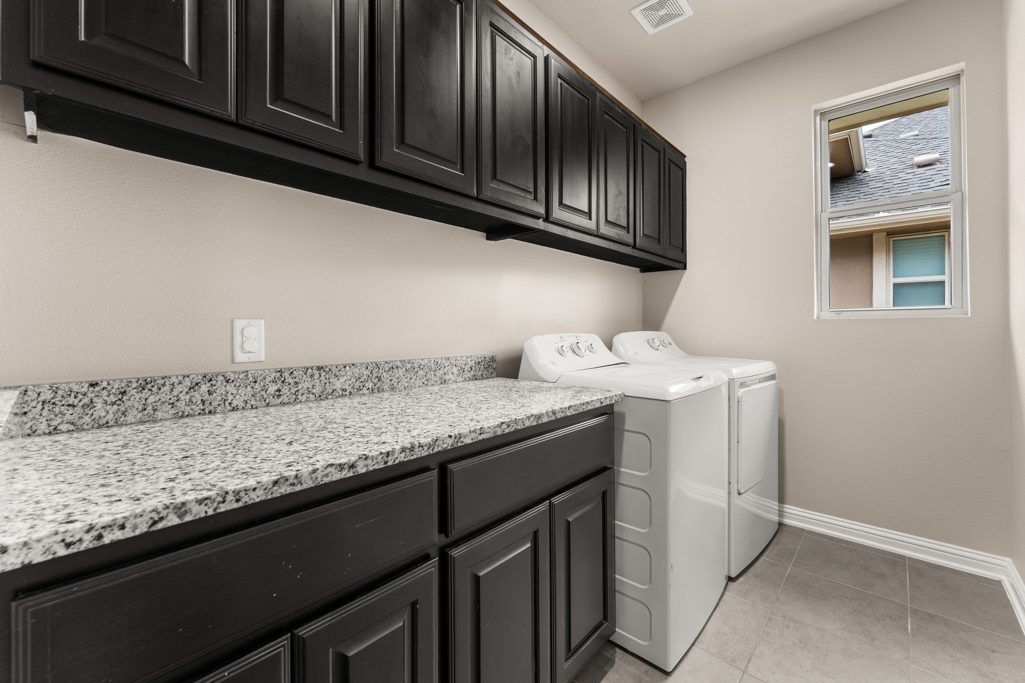 6814 East Riverside Drive, Unit 21 Austin, TX 78741 - Photo 23 of 35 a utility room with granite countertop cabinets washer and dryer