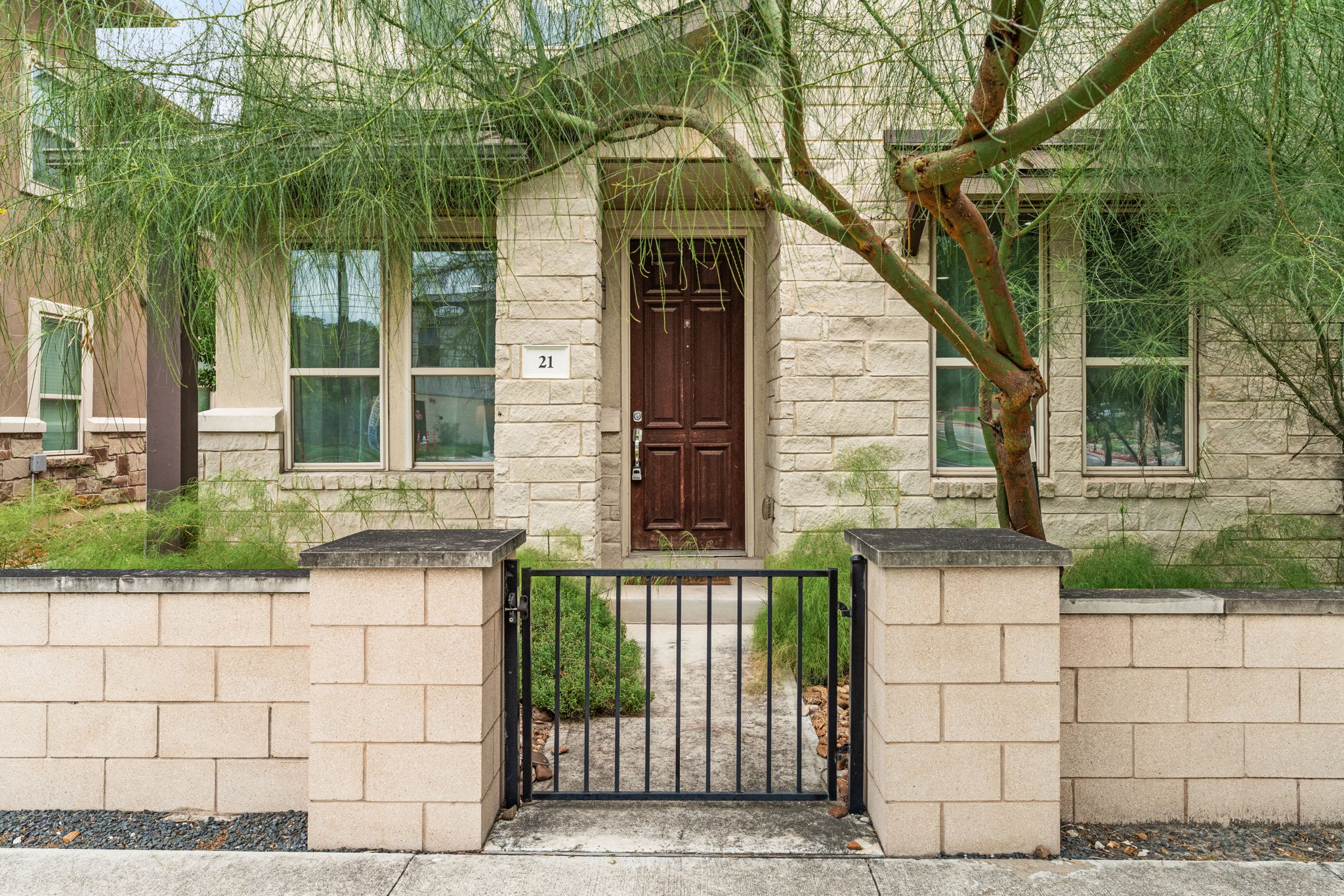 6814 East Riverside Drive, Unit 21 Austin, TX 78741 - Photo 3 of 35 a front view of a house with a garden