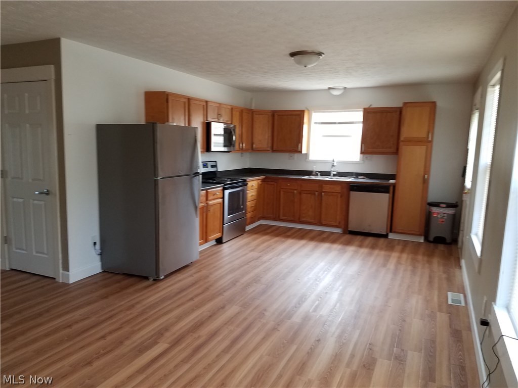 75 East Ohio Avenue Rittman, OH 44270 - Photo 5 of 17 Kitchen with brand new refrigerator, Stove, Microwave and Dishwasher