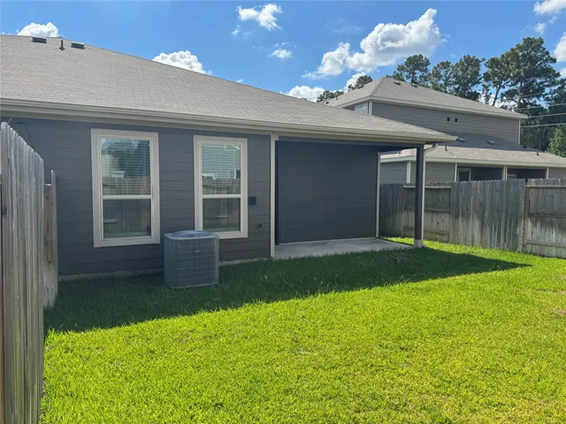 a view of a house with a yard and potted plants
