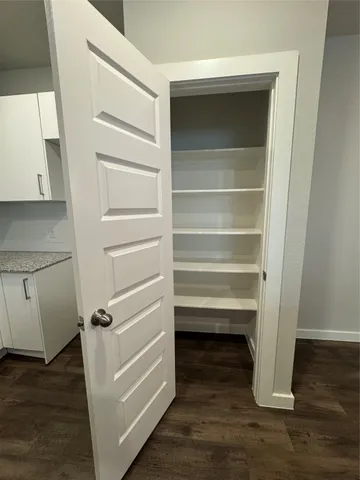a view of walk in closet with empty racks