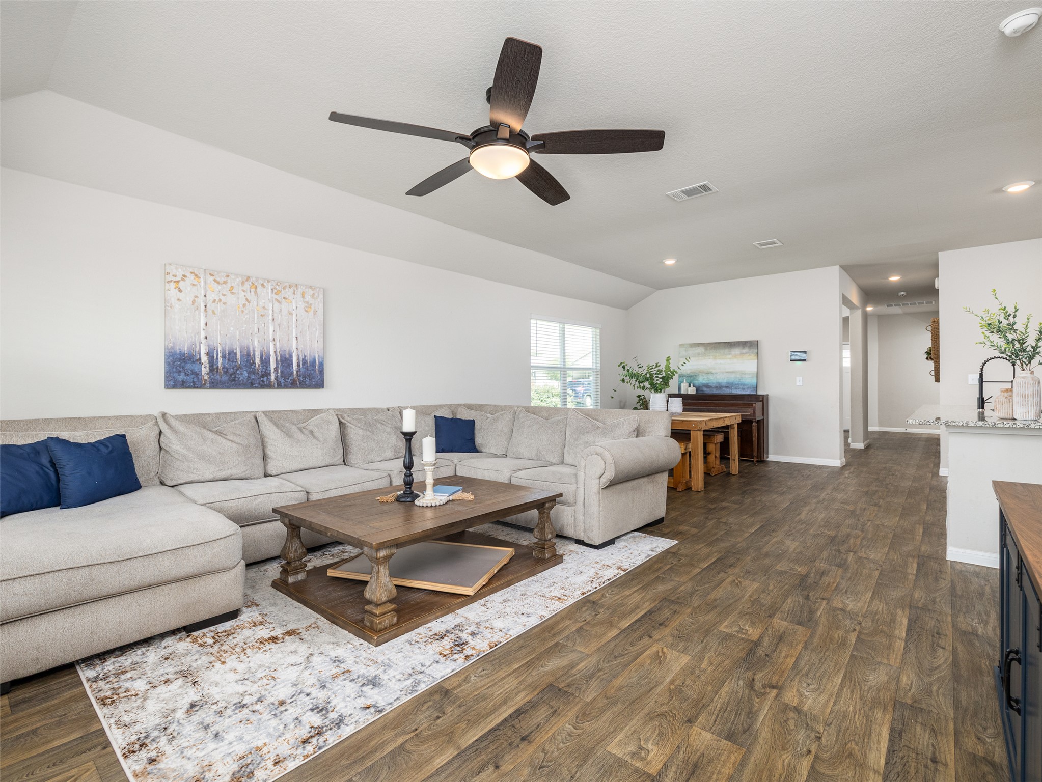 439 Hunter Loop Bertram, TX 78605 - Photo 7 of 23 A sprawling living room features ample natural light and durable wood-look flooring.
