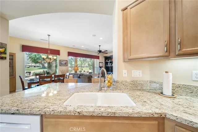 a kitchen with granite countertop a sink and a counter top space