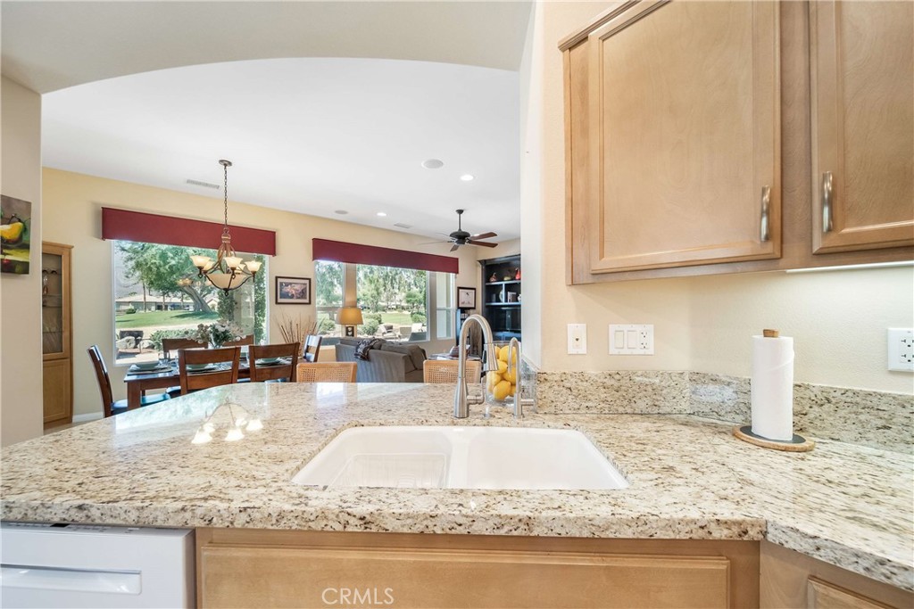 81955 Golden Star Way La Quinta, CA 92253 - Photo 13 of 54 a kitchen with granite countertop a sink and a counter top space