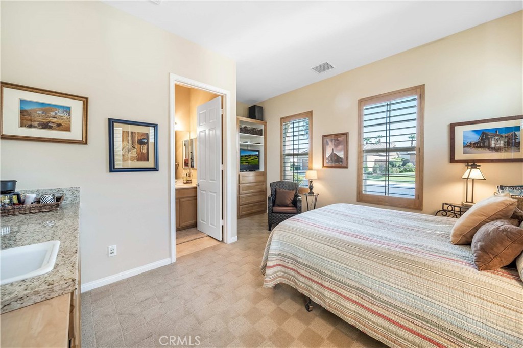 81955 Golden Star Way La Quinta, CA 92253 - Photo 19 of 54 a bedroom with a bed and a couch
