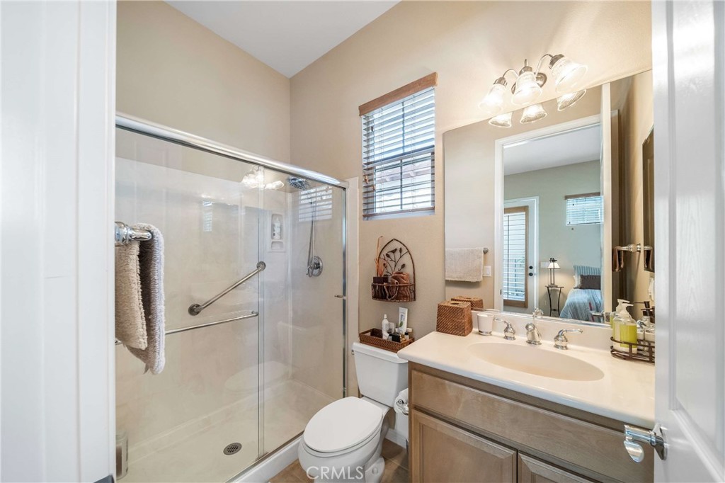 81955 Golden Star Way La Quinta, CA 92253 - Photo 21 of 54 a bathroom with a sink a toilet a mirror and shower