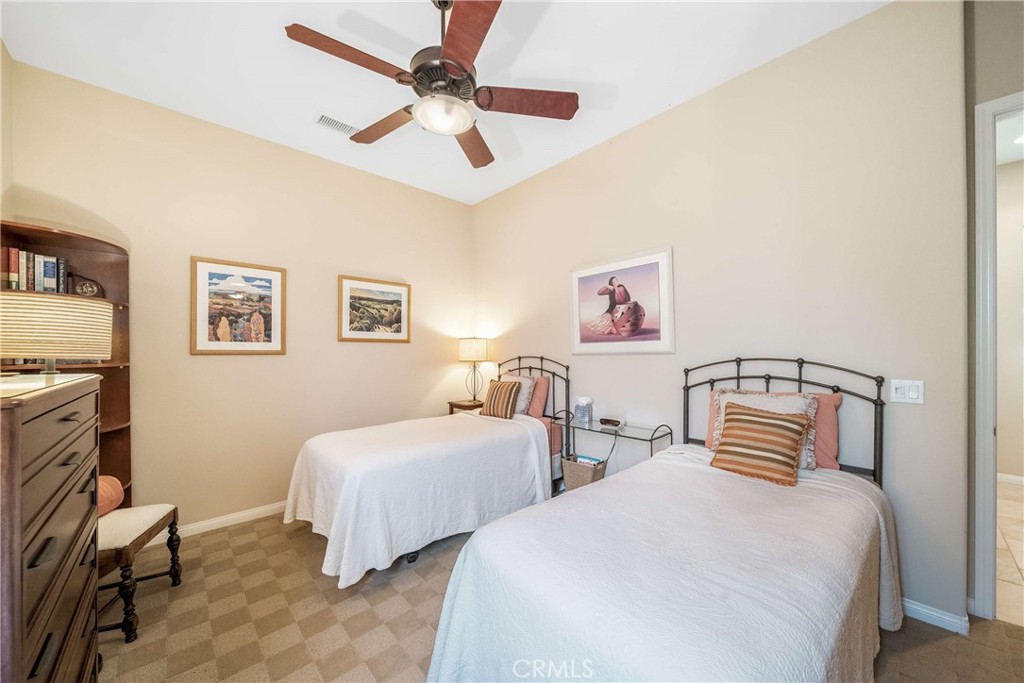 81955 Golden Star Way La Quinta, CA 92253 - Photo 22 of 54 a bedroom with two beds and a chandelier