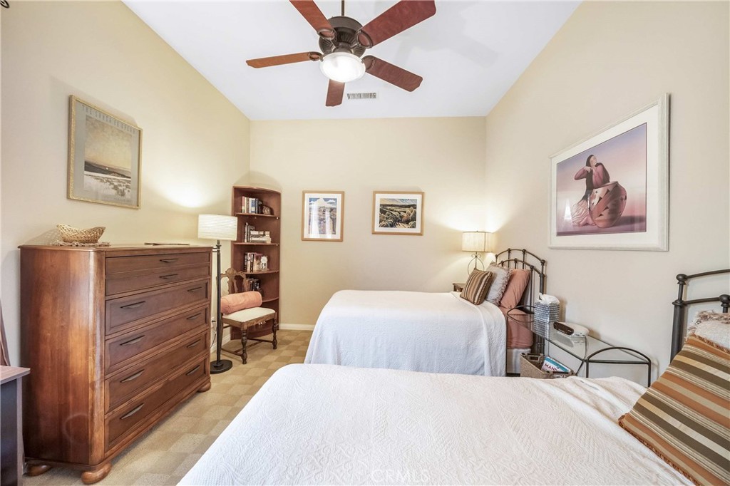 81955 Golden Star Way La Quinta, CA 92253 - Photo 24 of 54 a bedroom with a bed and a chandelier