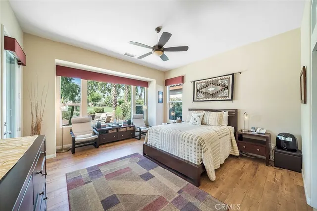 a bedroom with a large bed and a chandelier