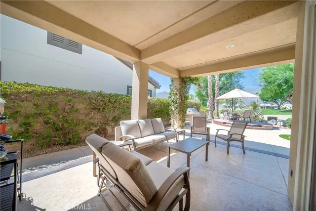 a view of a house with swimming pool and sitting area