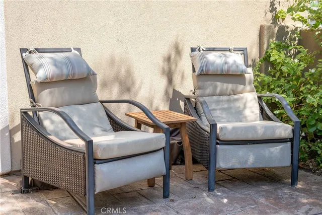 a view of a swimming pool with outdoor seating