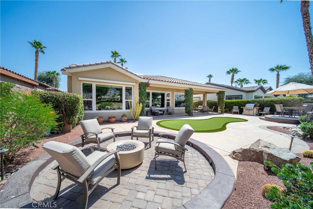 81955 Golden Star Way La Quinta, CA 92253 - Photo 45 of 54 a view of a swimming pool with lawn chairs and plants