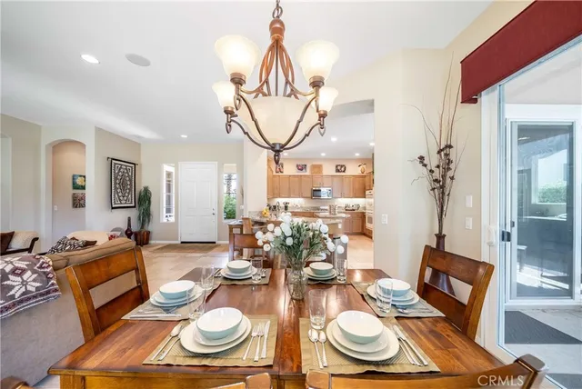 a view of a dining room with furniture wooden floor and chandelier