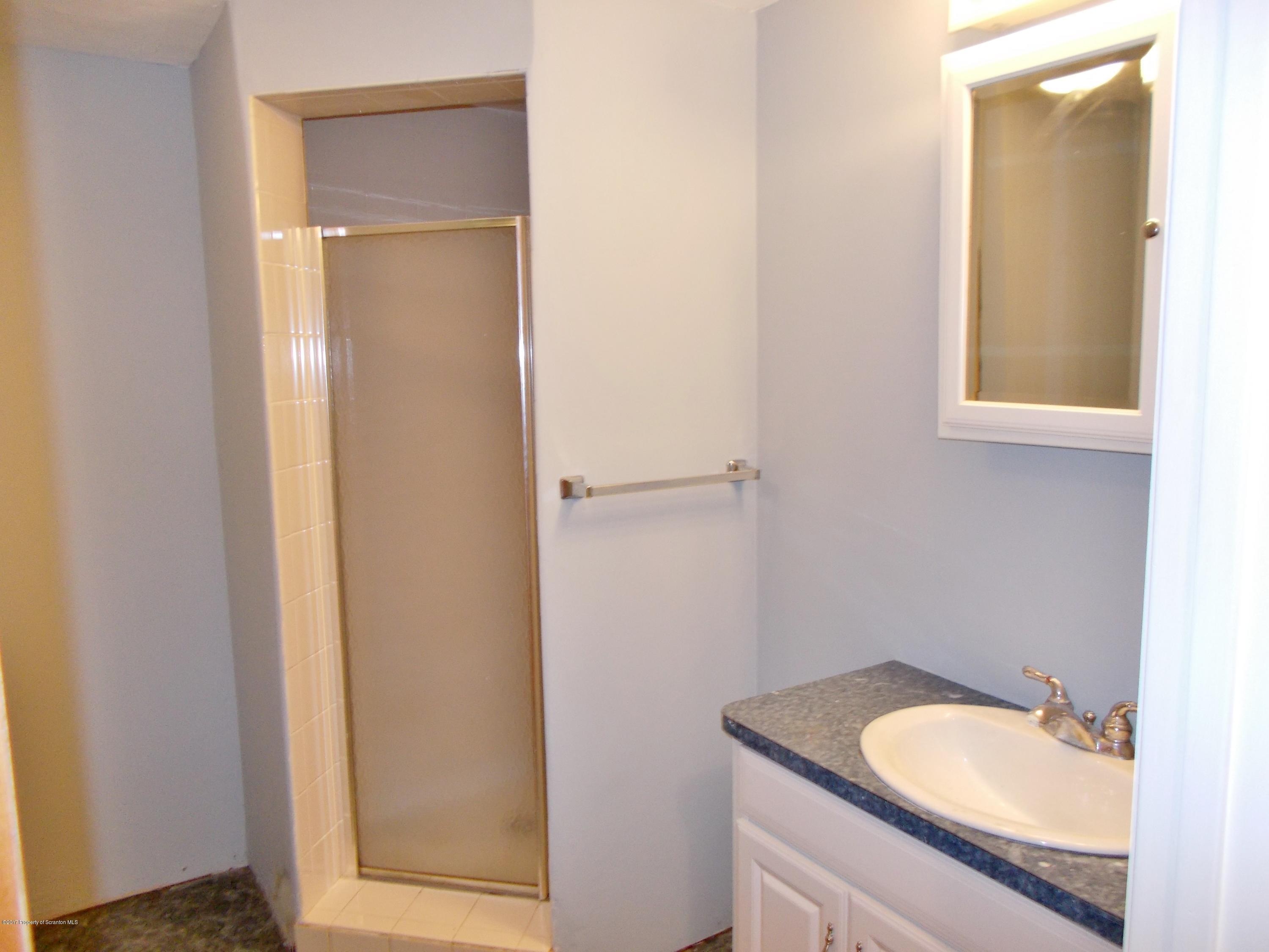 6 Watrees Rd Spring Brook Springfield, NJ 07081 - Photo 17 of 23 a bathroom with a granite countertop sink and a mirror