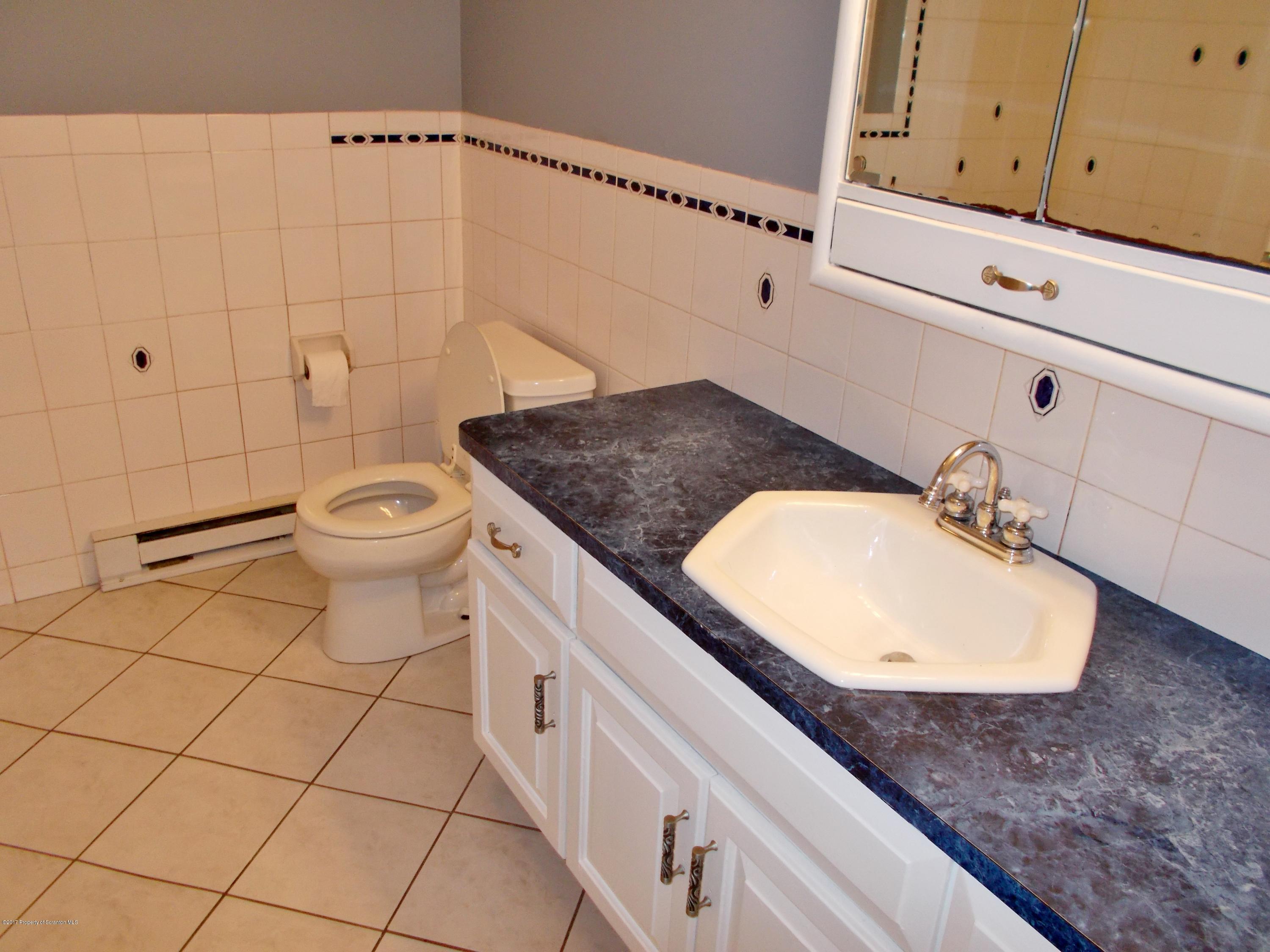 6 Watrees Rd Spring Brook Springfield, NJ 07081 - Photo 18 of 23 a bathroom with a sink a toilet and mirror