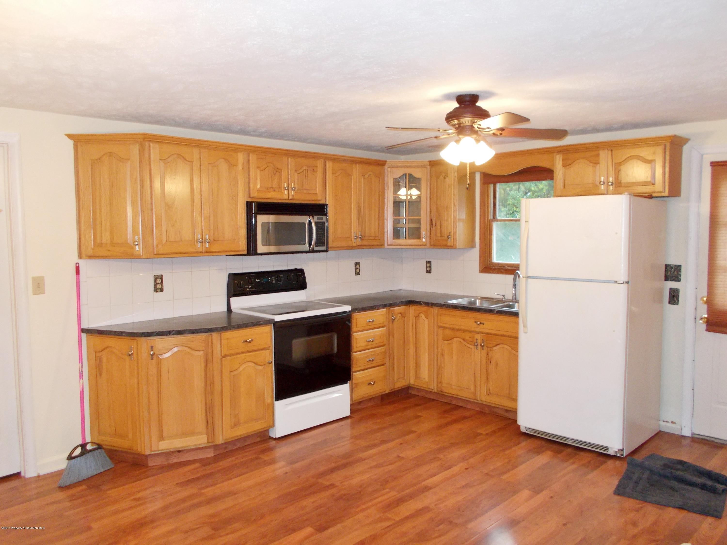6 Watrees Rd Spring Brook Springfield, NJ 07081 - Photo 2 of 23 a kitchen with granite countertop wooden floors stainless steel appliances and a refrigerator