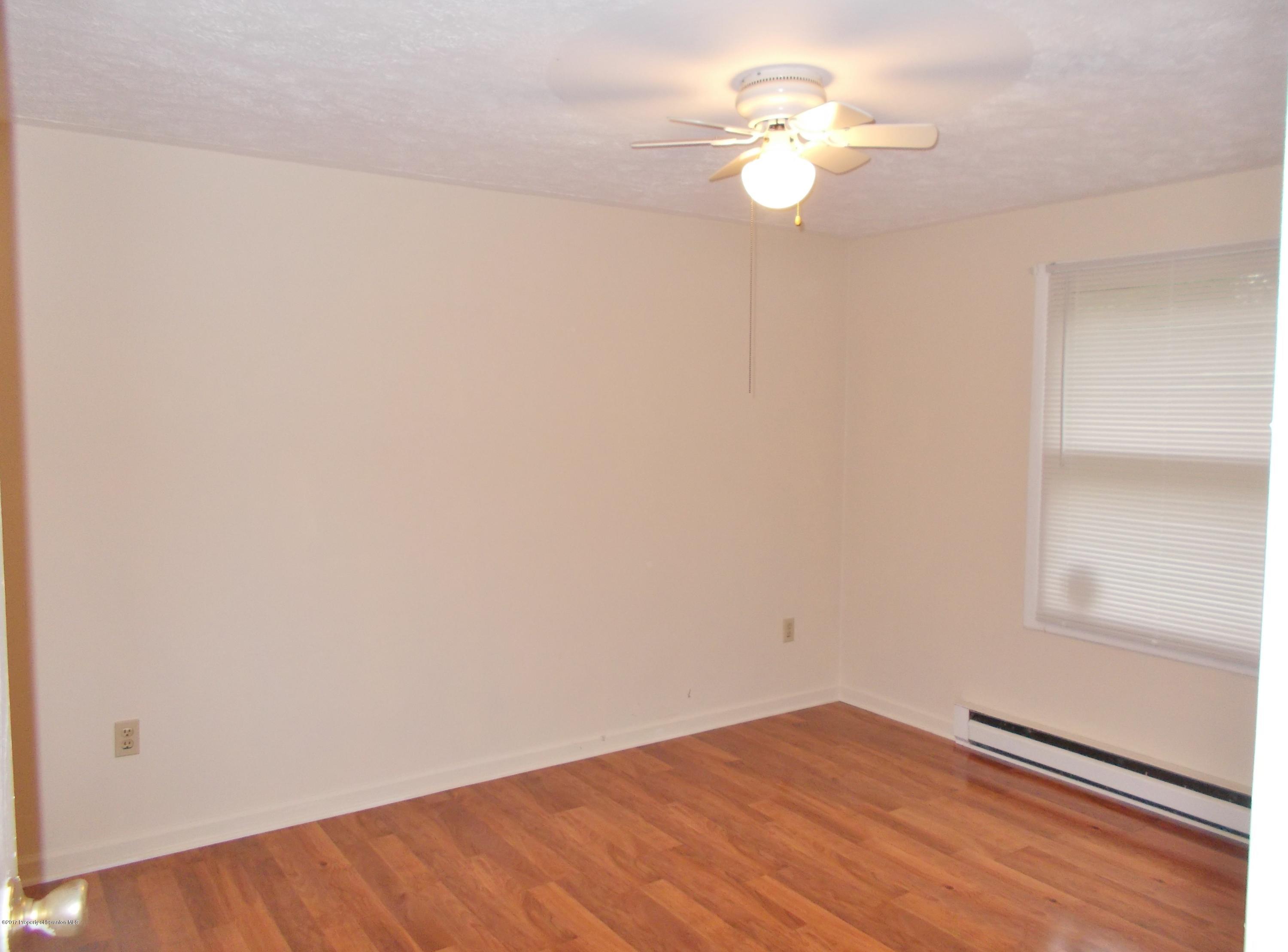 6 Watrees Rd Spring Brook Springfield, NJ 07081 - Photo 10 of 23 a view of an empty room with a ceiling fan and a window