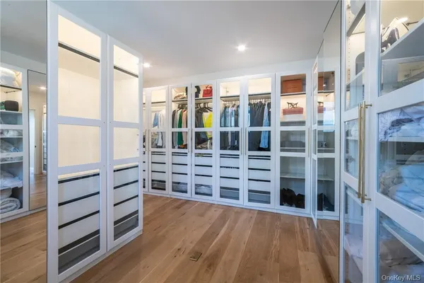 a view of walk in closet with wooden floor