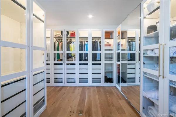 a view of walk in closet with empty racks