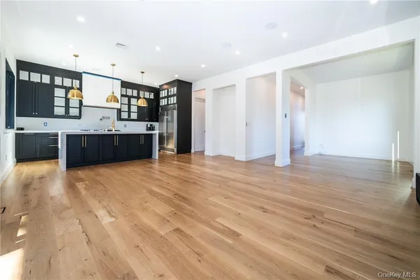 a large kitchen with stainless steel appliances granite countertop a large counter top and a stove