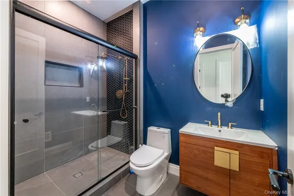 a bathroom with a toilet sink and shower