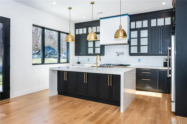 a kitchen with a sink cabinets and window