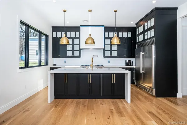 a kitchen with stainless steel appliances granite countertop a stove a sink and a refrigerator