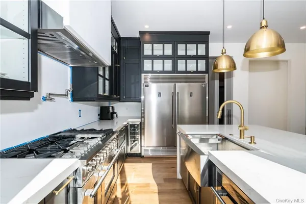 a kitchen with stainless steel appliances granite countertop a sink stove and refrigerator