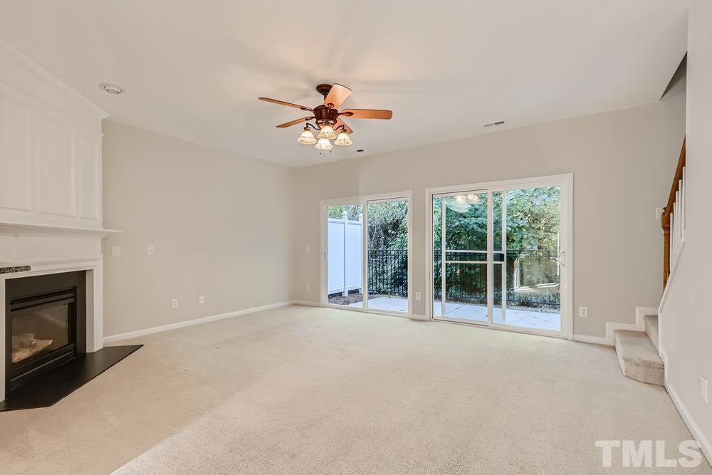 7010 Racine Way Raleigh, NC 27690 - Photo 3 of 27 a view of an empty room with a fireplace and a window