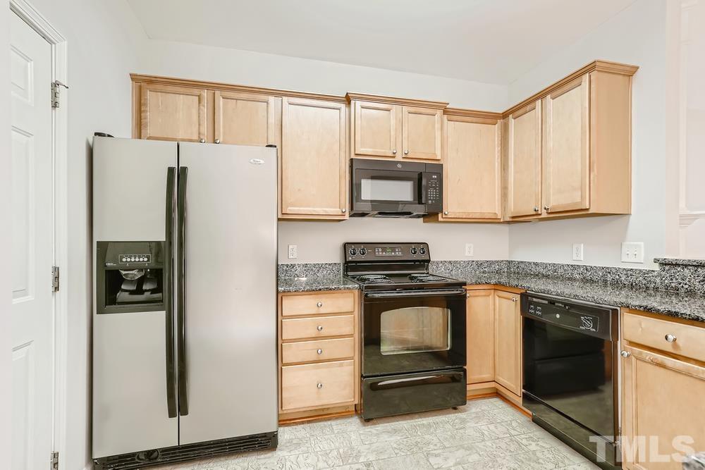 7010 Racine Way Raleigh, NC 27690 - Photo 8 of 27 a kitchen with stainless steel appliances granite countertop a refrigerator stove and microwave