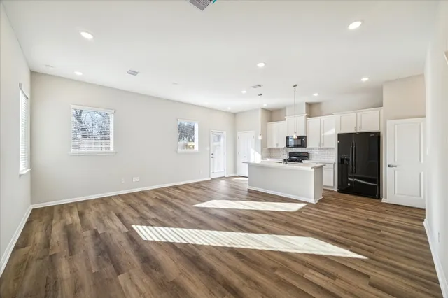a view of kitchen with wooden floor and electronic appliances