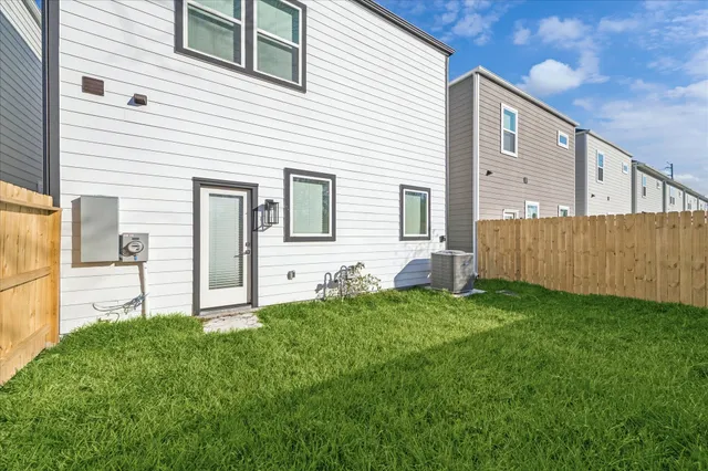 a backyard of a house with table and chairs