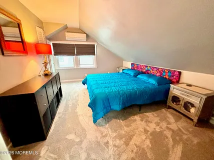 a bedroom with a bed and a stove