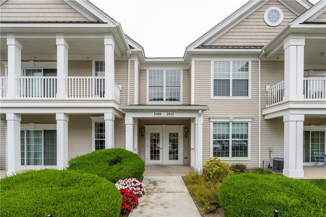 front view of a brick house with a yard