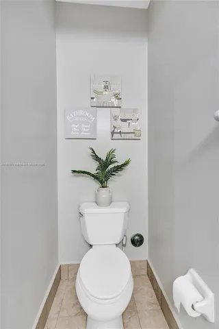 a white toilet sitting next to a bathroom sink