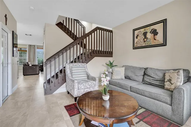 a living room with furniture and a dining table