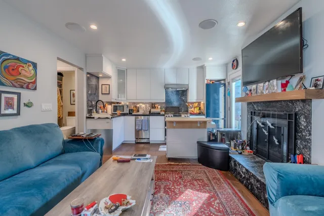 a living room with furniture and a fireplace