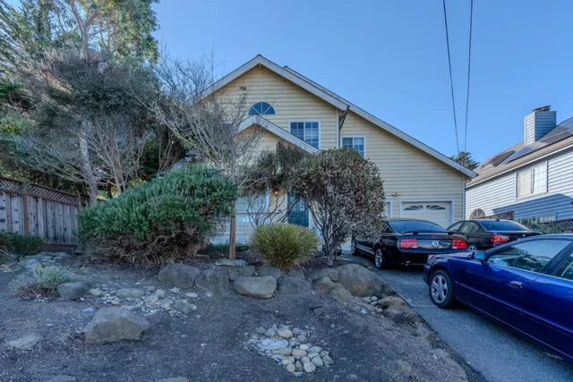 a front view of a house with garden