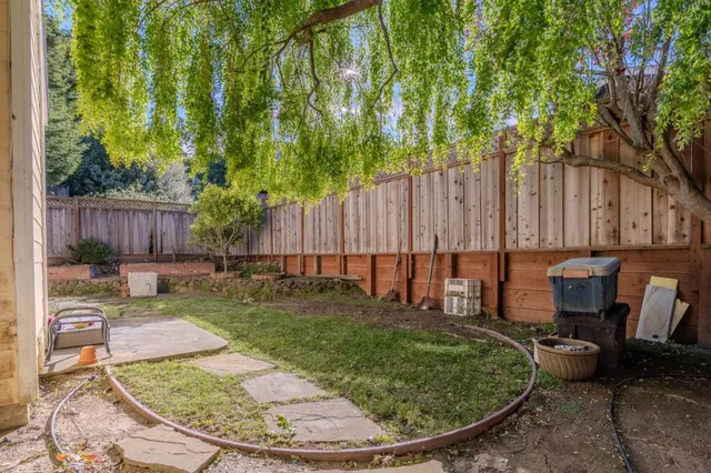 a view of a backyard with a patio and outdoor seating