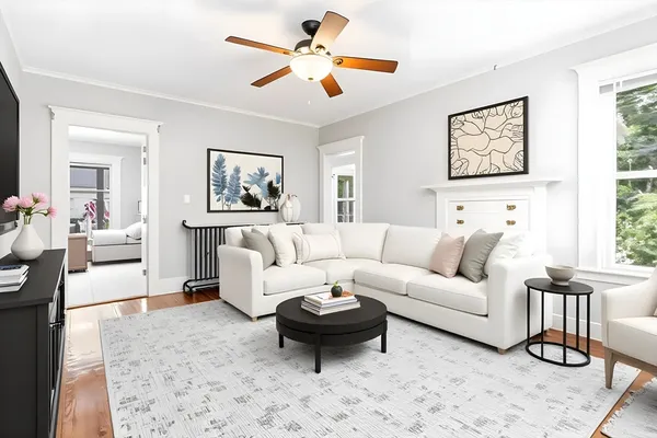 a living room with furniture a rug and a window
