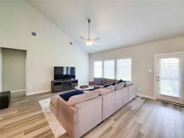 a living room with furniture and a painting on the wall