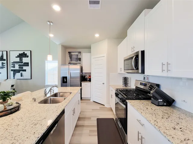 a living room with furniture a large window and a flat screen tv