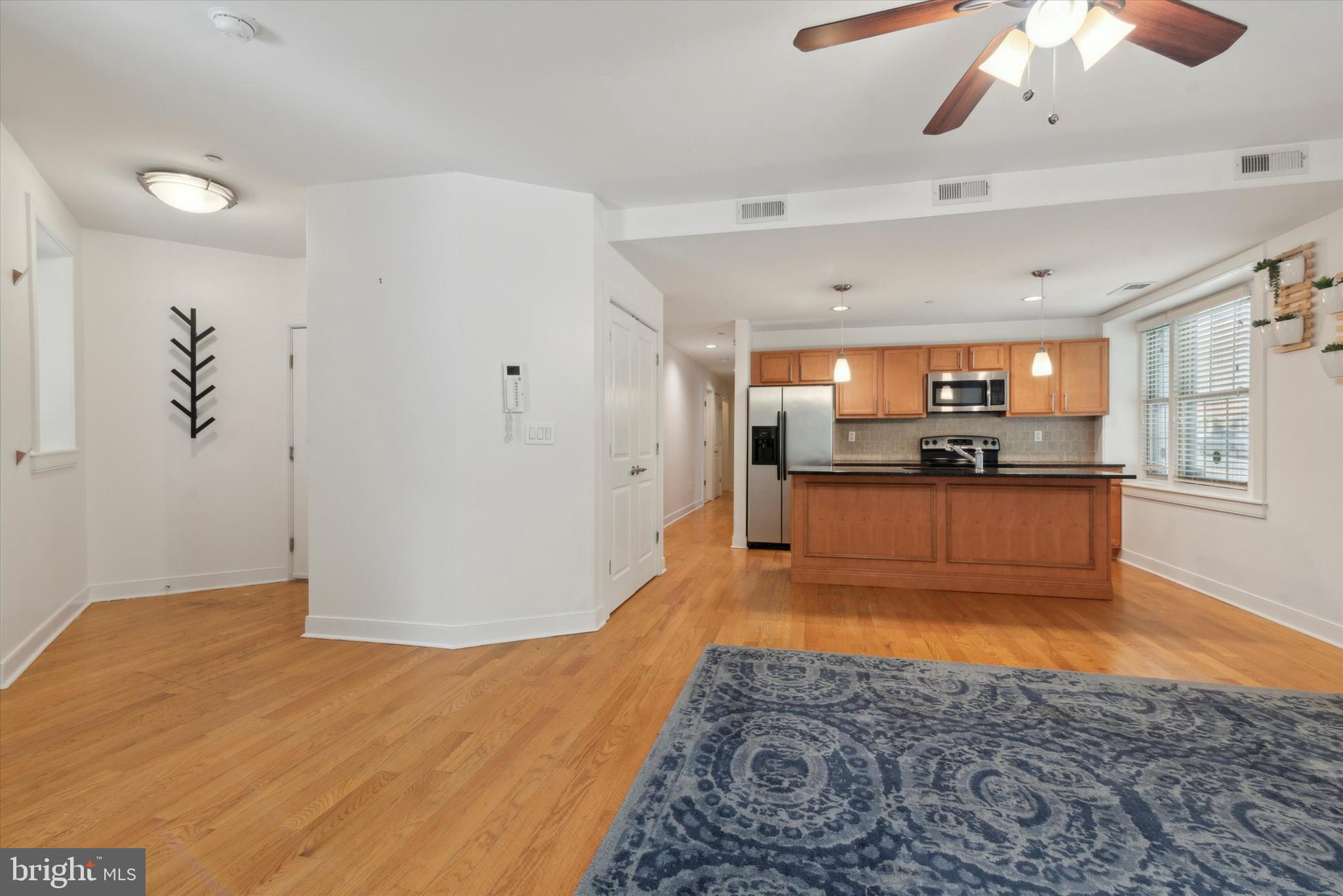 4300 Spruce Street, Unit A101 Philadelphia, PA 19104 - Photo 4 of 25 a kitchen with stainless steel appliances kitchen island granite countertop a refrigerator and a sink