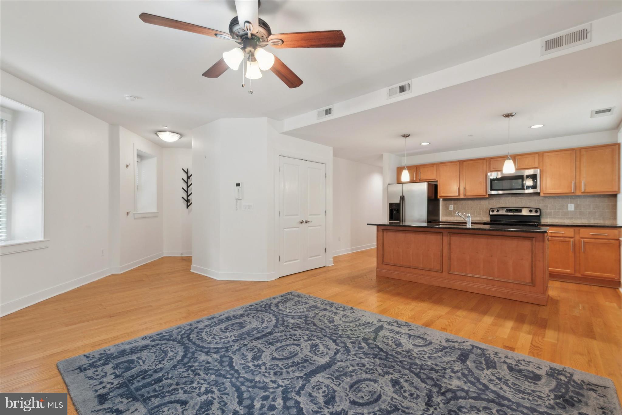 4300 Spruce Street, Unit A101 Philadelphia, PA 19104 - Photo 6 of 25 a large kitchen with stainless steel appliances granite countertop a stove and a refrigerator
