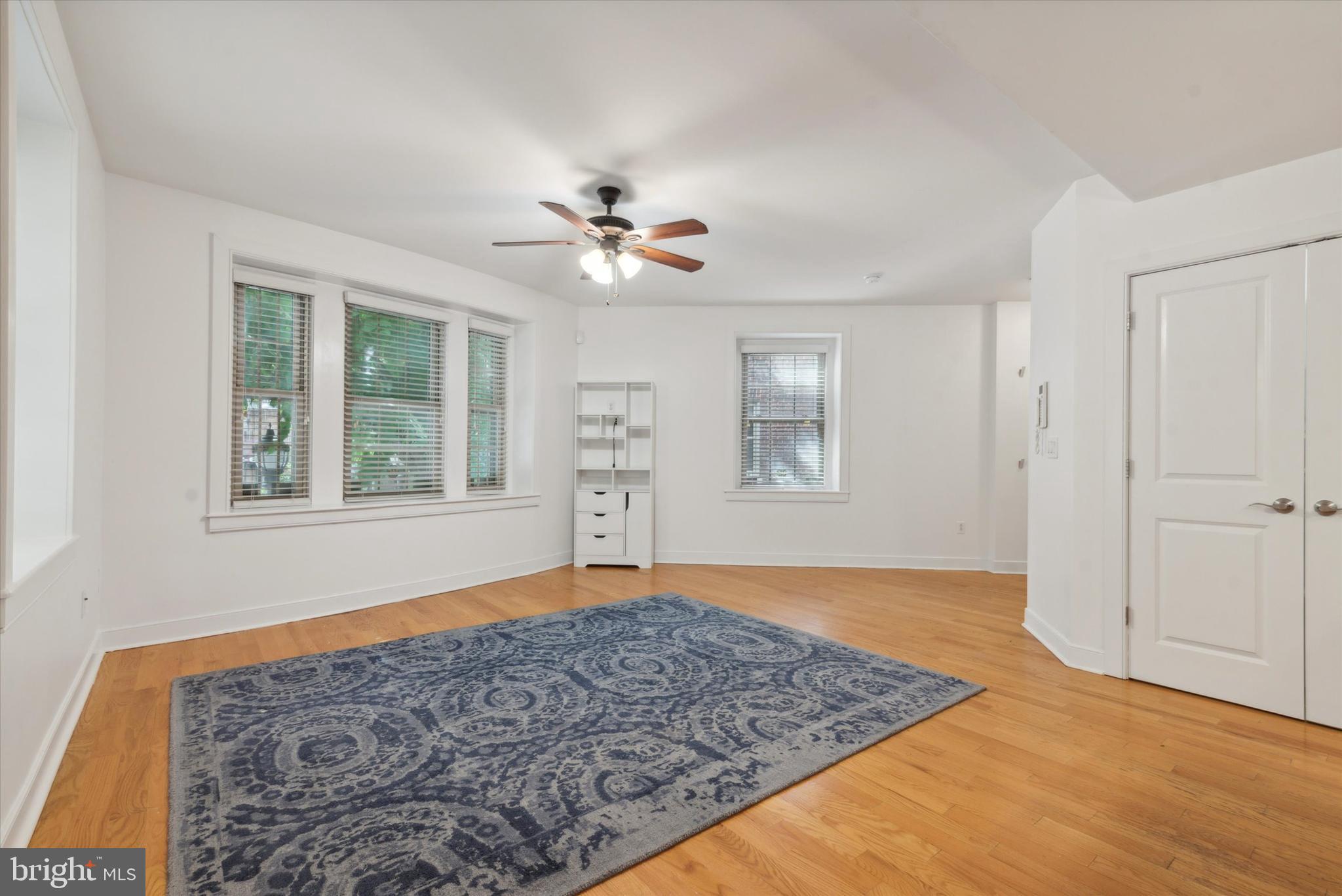 4300 Spruce Street, Unit A101 Philadelphia, PA 19104 - Photo 8 of 25 wooden floor in an empty room with a window